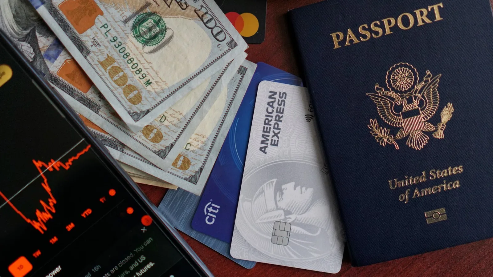 Passport, cards, cash, and phone arranged for planning a Korea travel budget